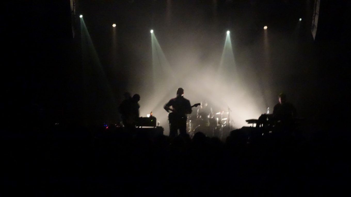 Silhouette outline of a performer on stage
